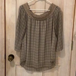 A pretty chiffon style lined blouse with delicate smocking around neckline